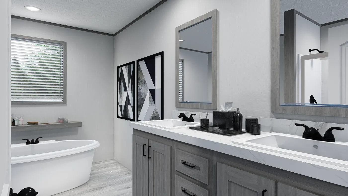 Baño principal de la casa móvil Lewis 28x62 con doble lavabo y tina